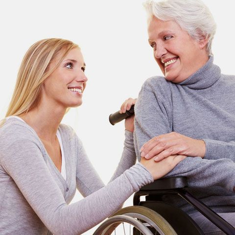 caregiver helping senior woman
