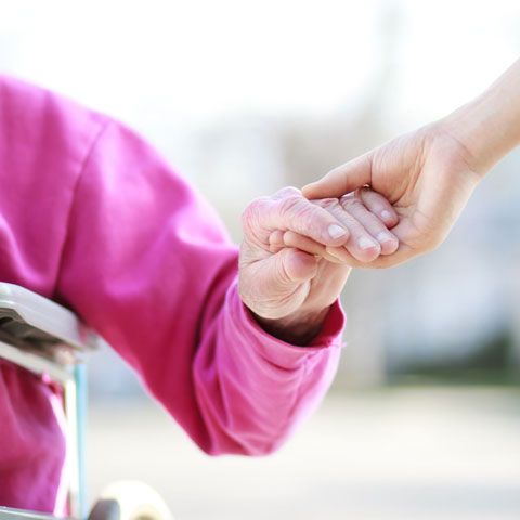caregiver helping senior woman